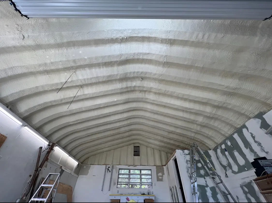 Spray polyurethane foam applied to the underside of a metal roof deck in Newtown
